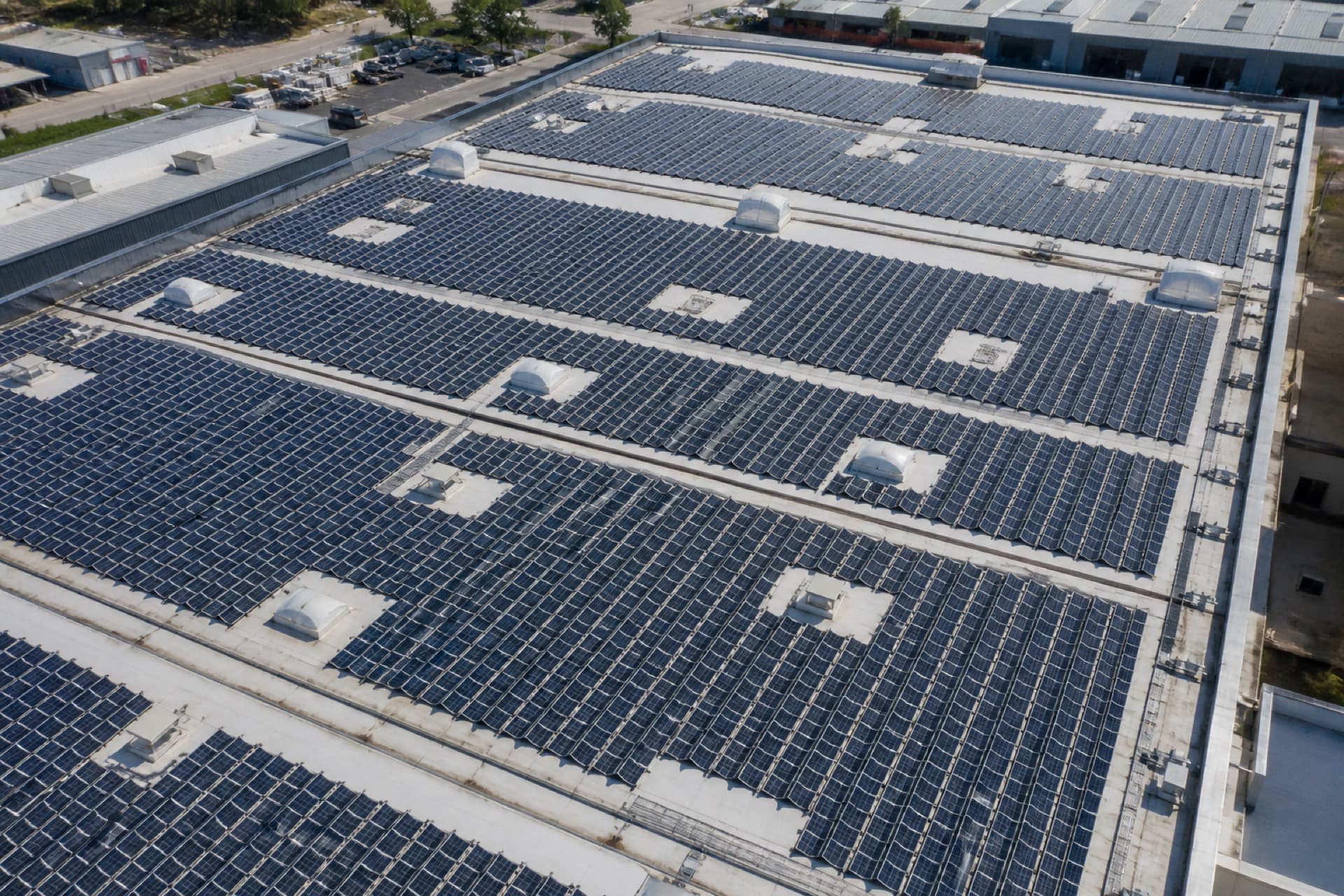 Aerial rooftop covered in solar arrays